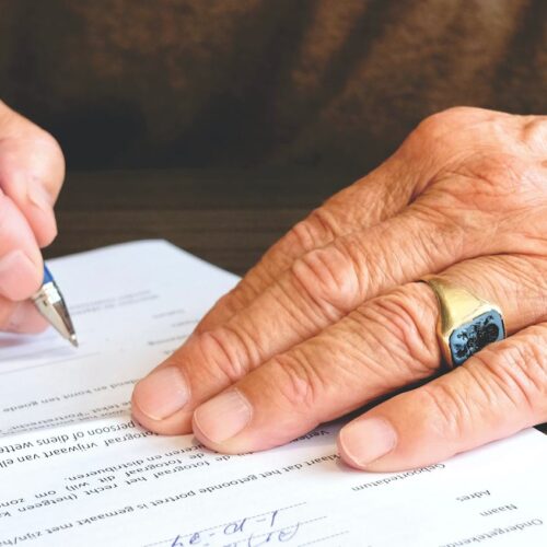 man signing small business loan